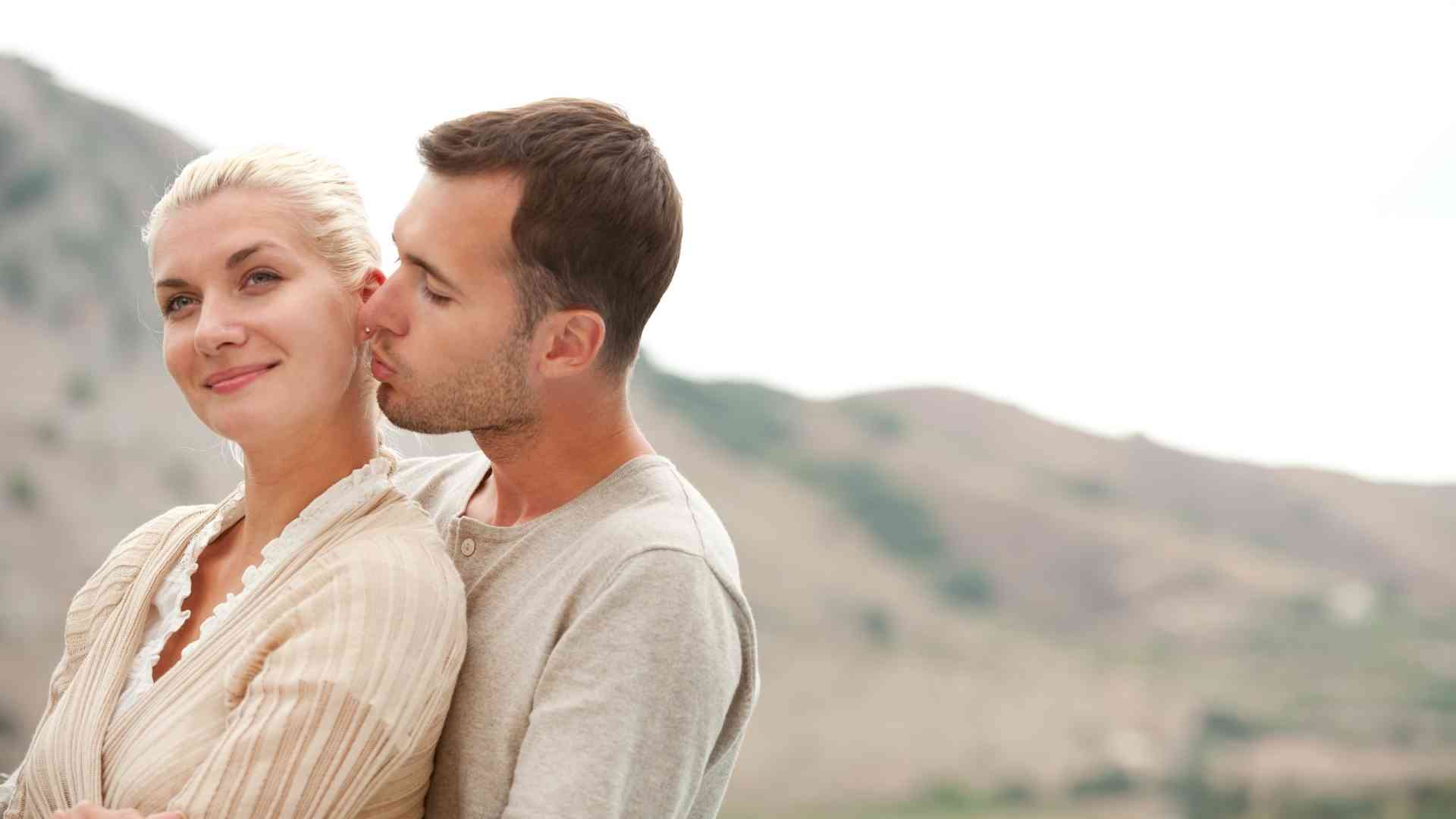 man kissing a woman from the back madly in love