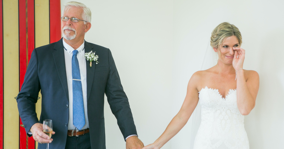 bride and father holding hands